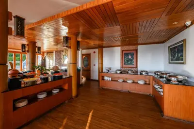 a large kitchen with wooden walls and wooden floors at Karon Phunaka Resort in Karon Beach