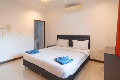 a bedroom with a large bed with blue towels on it at JUNGLE APARTMENT2 BEDROOMS PRIVATE POOl in Kamala Beach