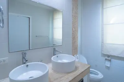 a white bathroom with a sink and a toilet at JUNGLE APARTMENT2 BEDROOMS PRIVATE POOl in Kamala Beach