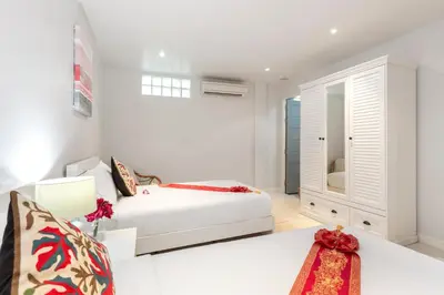 a white bedroom with a bed and a desk at Kamala Beach House - 1 min walk to beach in Kamala Beach