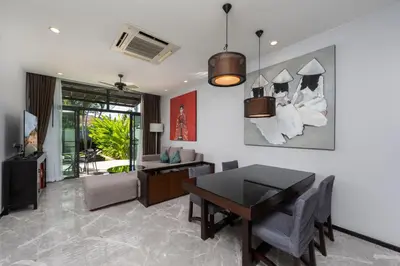 a living room with a table and a dining room at VILLA Galam 2BR Private Pool Naiharn beach in Nai Harn Beach
