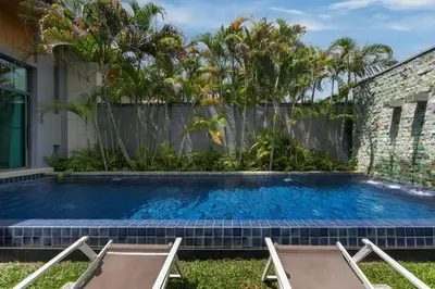 a swimming pool in the yard of a house at VILLA ATA Private Pool Nai harn beach in Nai Harn Beach