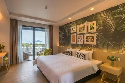 a hotel room with a bed and a balcony at Panan Krabi Resort in Ao Nang Beach