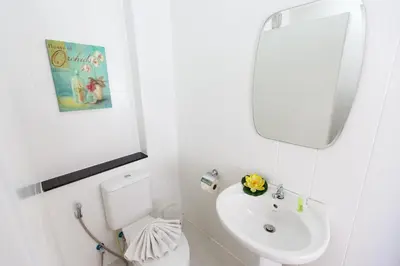 a white bathroom with a sink and a mirror at YaYa B By Briza Group in Chalong