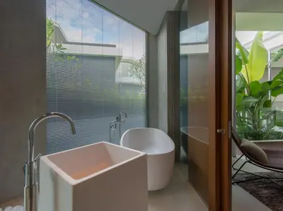 a bathroom with a tub and a sink and a window at Villa Abiente in Thalang