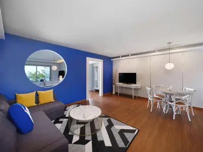 a living room with a couch and a table at Homm Bliss Southbeach Patong in Patong Beach