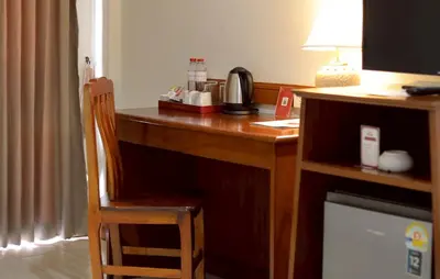 a desk in a hotel room with a chair next to it at Tony Resort in Patong Beach