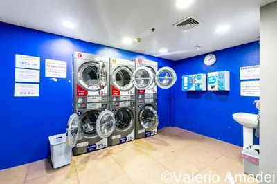 a room with three washing machines in a blue wall at Phuket Villa Patong Beach by PHR in Patong Beach