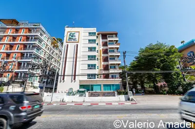 a tall white building with a clock tower at Phuket Villa Patong Beach by PHR in Patong Beach