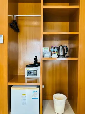 a small kitchen with a stove and a microwave at PJ Patong Resortel in Patong Beach