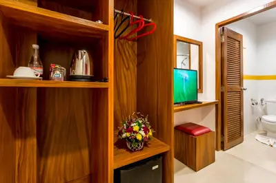 a bathroom with a toilet and a television in it at PJ Patong Resortel in Patong Beach