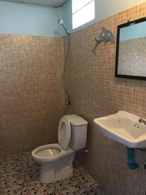 a bathroom with a toilet and a sink at Golden Hill Guesthouse in Phi Phi Don