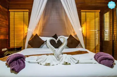 a bedroom with a bed with two swans in the middle at Baan Habeebee Resort in Ao Nang Beach
