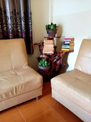 a room with two chairs and a table with books at Kata Leaf Resort Phuket - in Kata Beach