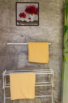 two towels on a towel rack in a bathroom at Kanya Cozy Bungalows Kata in Kata Beach