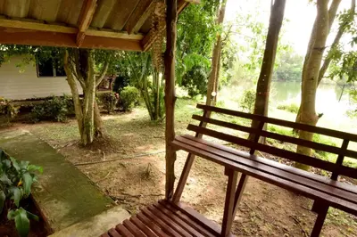 a bench sitting under a porch with a view of a lake at Aonang Lake Side in Ao Nang Beach