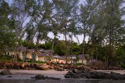 a row of houses on a beach with trees at Krabi Home Resort in Tab Kaek Beach