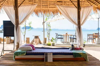 a bed in a tent with the beach in the background at Krabi Home Resort in Tab Kaek Beach