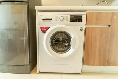 a washing machine in a kitchen next to a refrigerator at ZcapeX2 in Bang Tao Beach