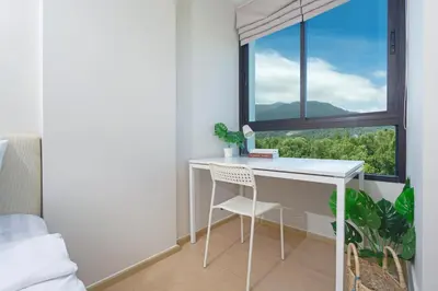 a white desk with a chair in a room with a window at ZcapeX2 in Bang Tao Beach