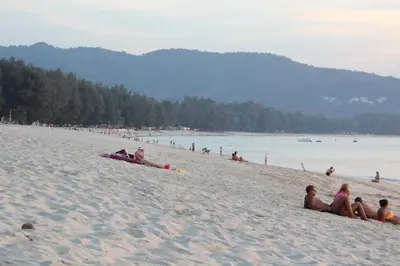 a group of people laying on a beach at KD Residence in Bang Tao Beach