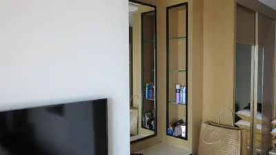 a living room with a tv and a mirror at 5* 3BR SUITE in Amari Phuket - Patong Beach in Patong Beach