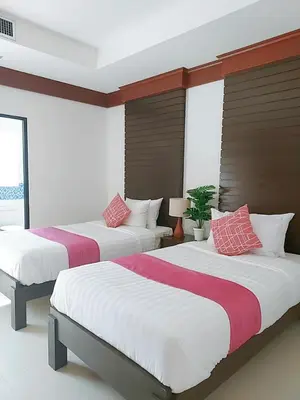a bedroom with two beds with red and white sheets at Aromdee at Naithon Beach in Nai Thon Beach