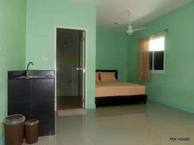 a bedroom with a bed and a sink in it at Pek House in Phuket Town