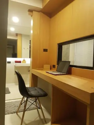 a laptop computer sitting on a wooden desk with a chair at 8IK88 Resort, Phuket - SHA Extra Plus in Por Bay