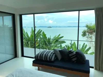 a bedroom with a view of the ocean at 8IK88 Resort, Phuket - SHA Extra Plus in Por Bay