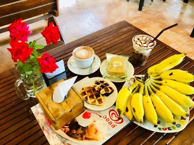 a table with plates of food and bananas on it at Baansuan Amaleena in Ko Yao Noi