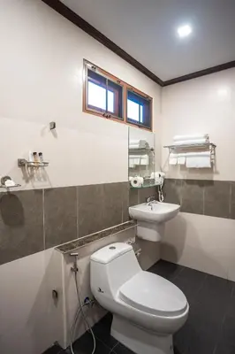 a bathroom with a white toilet and a sink at Pai Tan Villas - SHA Extra Plus in Bang Tao Beach