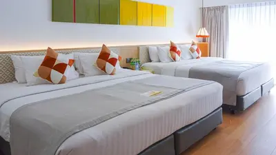 a hotel room with two beds in a room at The Lantern Resorts Patong in Patong Beach