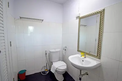 a bathroom with a sink and a toilet and a mirror at Anissa Resort Koh Yao Yai in Ko Yao Yai