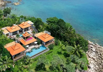 an aerial view of a house next to the ocean at Trisara Villas & Residences Phuket in Nai Thon Beach
