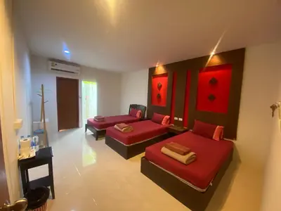 a living room with two beds and a couch at Pak Klong Room for rent in Phi Phi Don