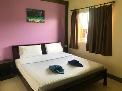 two towels are sitting on a bed in a bedroom at Pak Klong Room for rent in Phi Phi Don