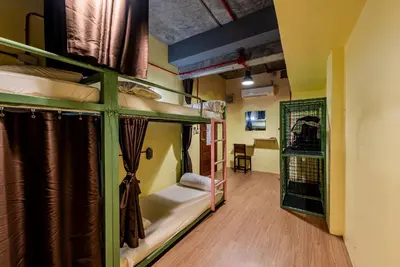 a room with two bunk beds and a hallway at Sleeper Hostel in Ao Nang Beach