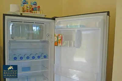 a white refrigerator with its door open with its door at MaiKhao Residence in Mai Khao Beach