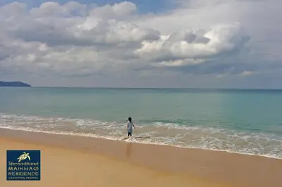 a person walking on the beach at MaiKhao Residence in Mai Khao Beach