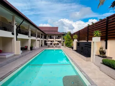 a swimming pool in the backyard of a house at Naiya Buree Boutique Resort Nai Harn Beach in Rawai Beach