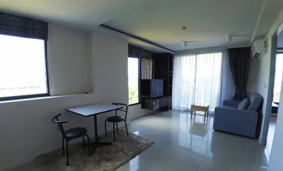 a living room with a table and chairs and a couch at 1-BR Sea View, Aristo condo, Surin Beach in Surin Beach