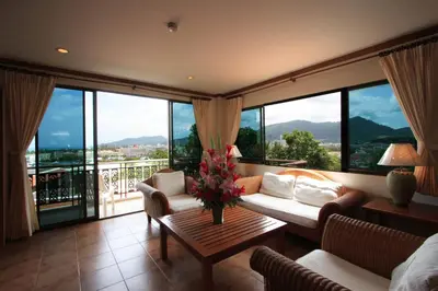 a living room with a couch and a table at Sun Hill Hotel Patong in Patong Beach