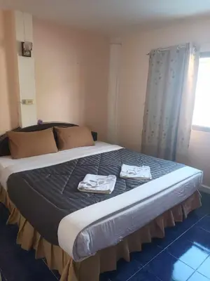 a bed in a room with two towels on it at Patong Rose Guest House 50m to Beach in Patong Beach
