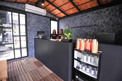 two women standing at a counter in a coffee shop at Glur Phuket Patong Beach in Patong Beach