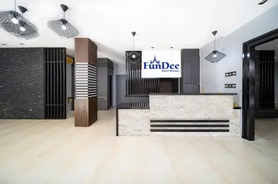 a room with a lobby with a fireplace and a sign at FunDee Boutique Hotel in Patong Beach