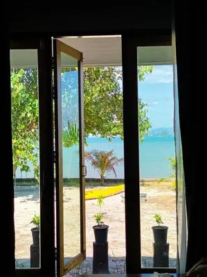 an open door with a view of the beach at Koh Yao Beach Front in Ko Yao Yai
