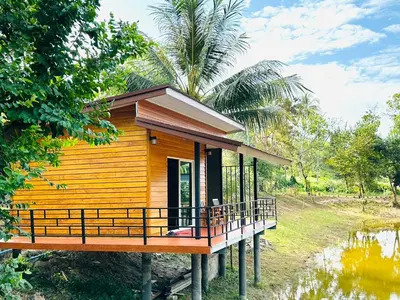 a small house on stilts in a forest at Koh Yao Beach Front in Ko Yao Yai