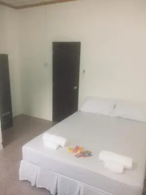 a bedroom with a white bed with towels on it at Hero Phuket in Nai Yang Beach