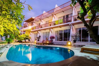 a swimming pool in front of a building at Layalina Hotel in Kamala Beach